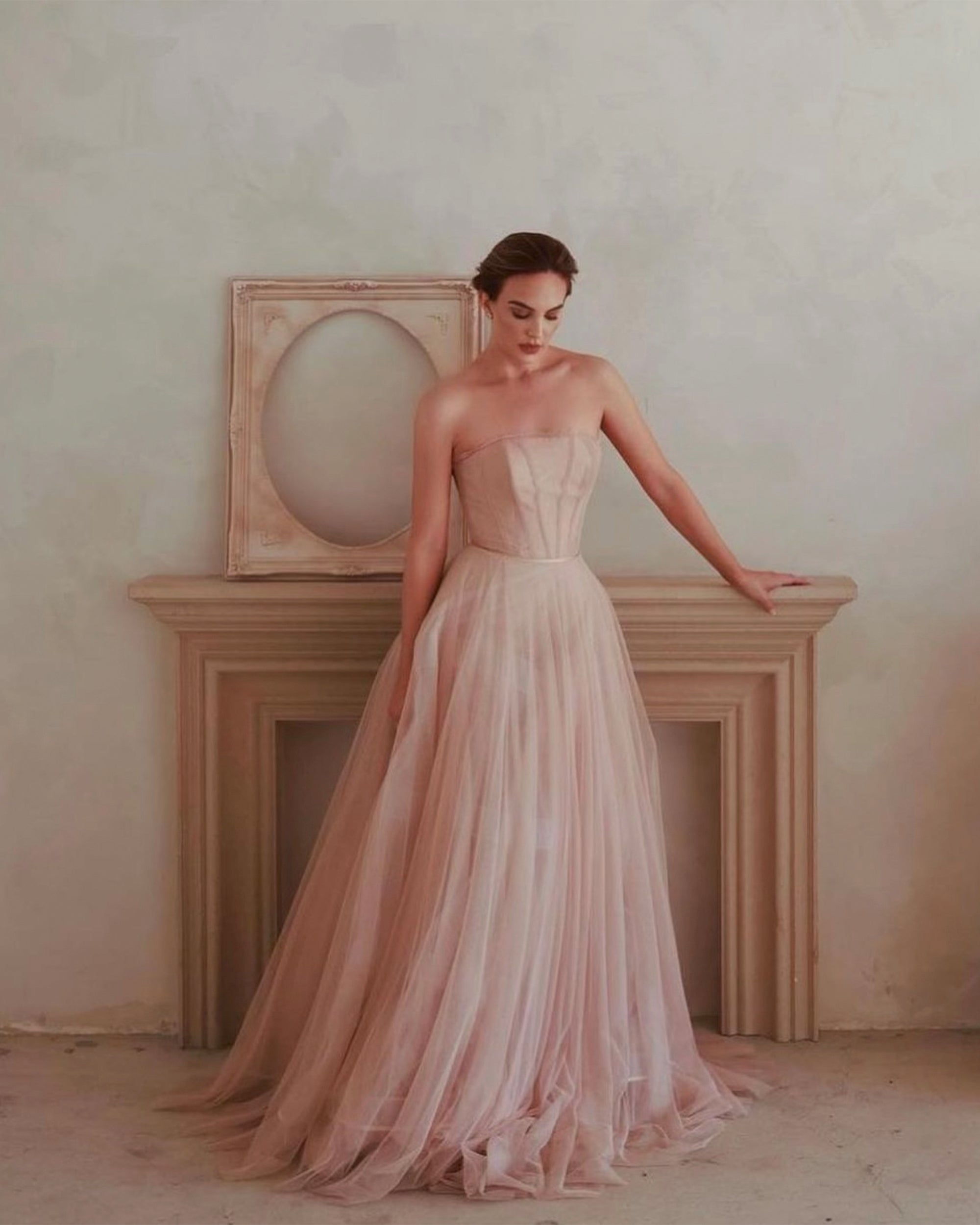 A beautiful woman posing in front of a fireplace and limewash panted textured wall