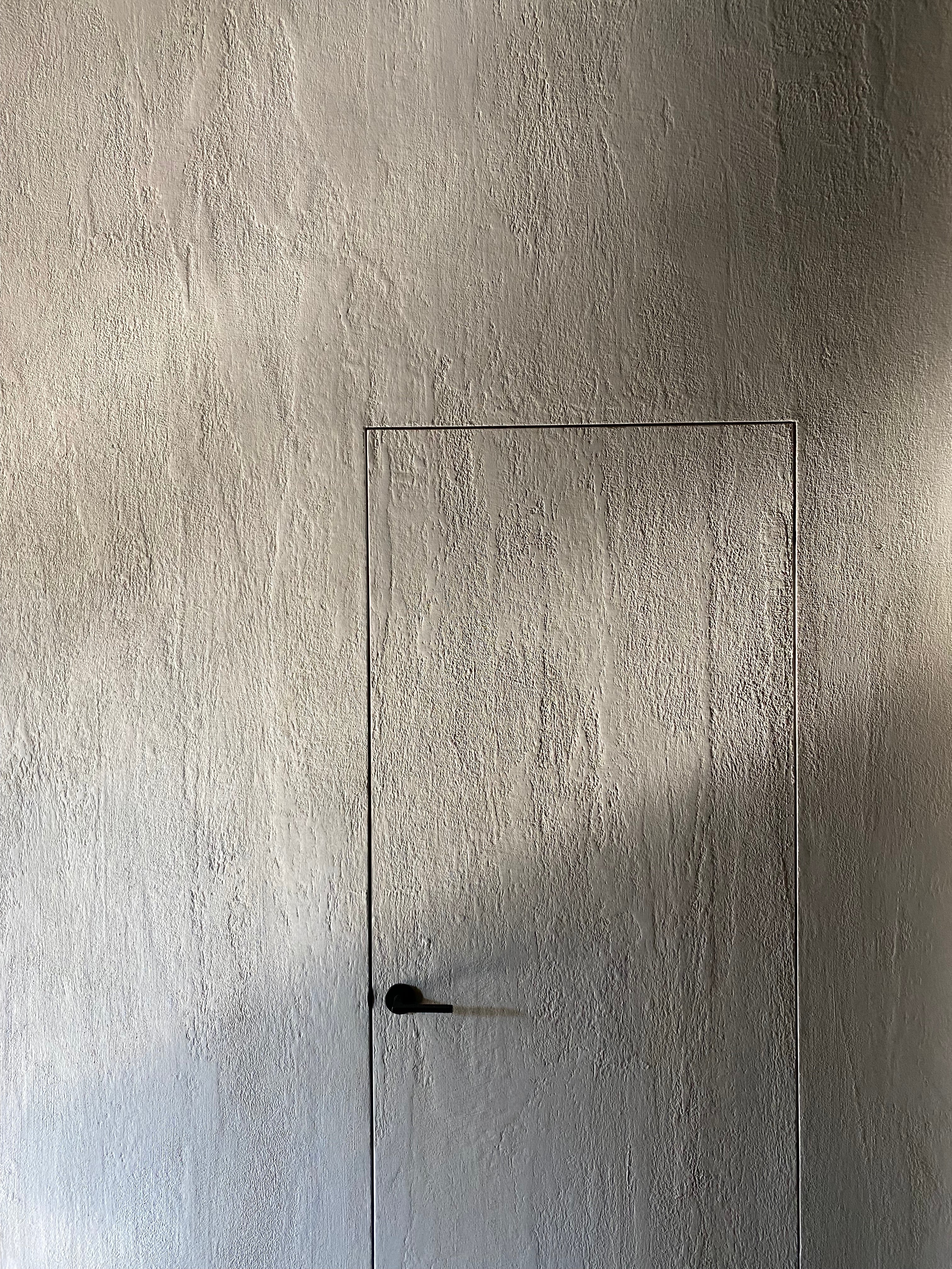 Doorway using lime wash wall paint 107 as well as lime slurry to create a textured look.