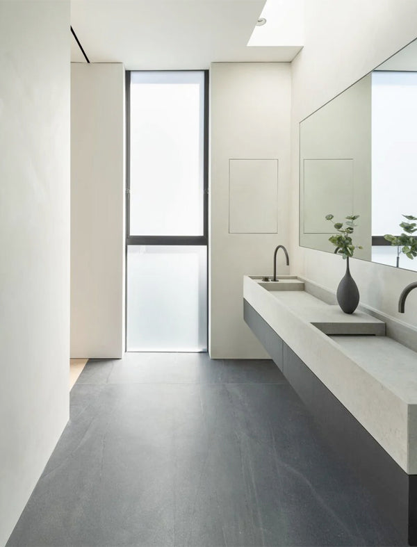 Dual bathroom sinks inside a modern bathroom painted with Limewash paint